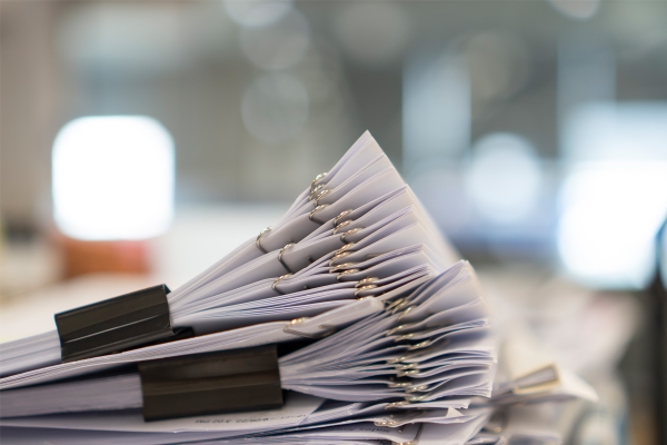stackofpaperdocumentmanyjobswaitingtobe20231127050451utc.jpg